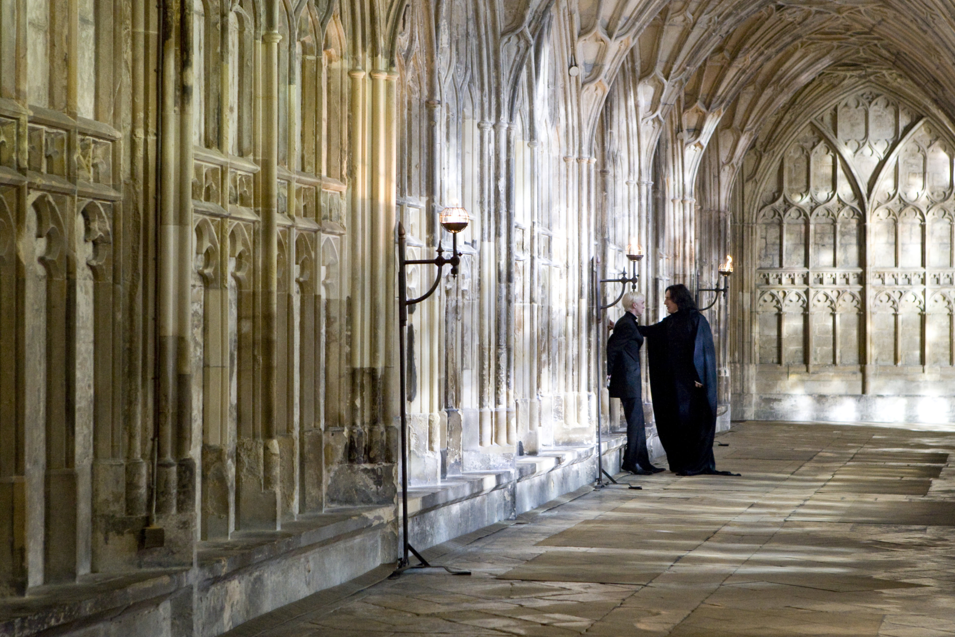 Snape threatens Draco in Hogwarts Hallway.